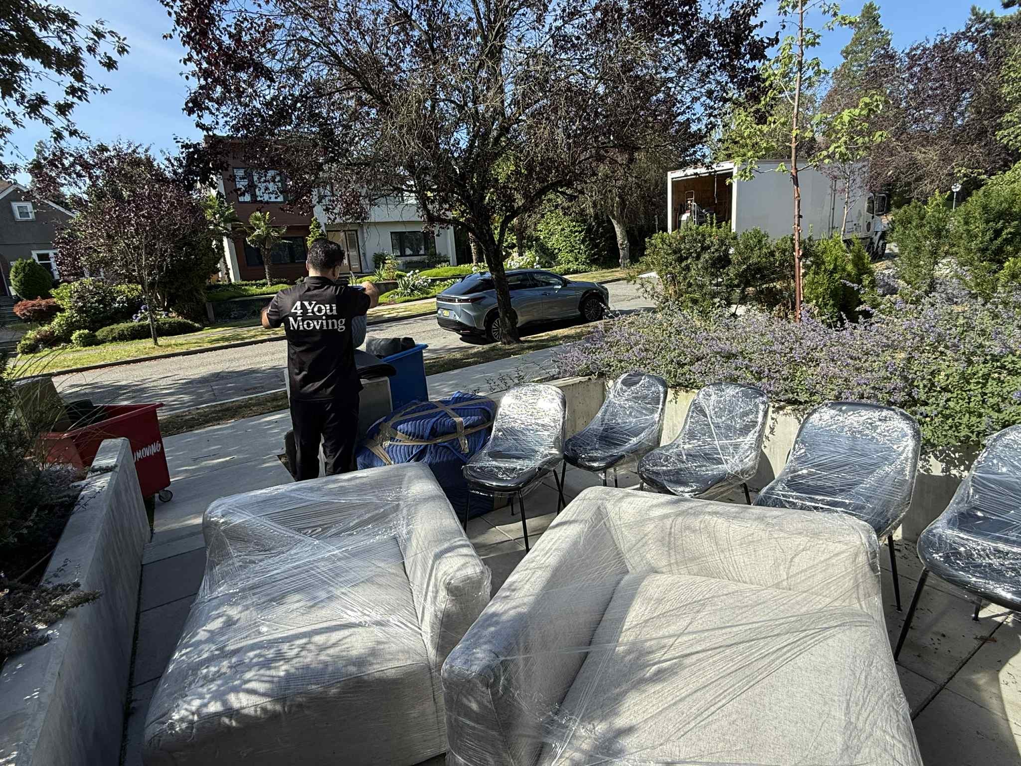 Professional movers carrying boxes into moving truck